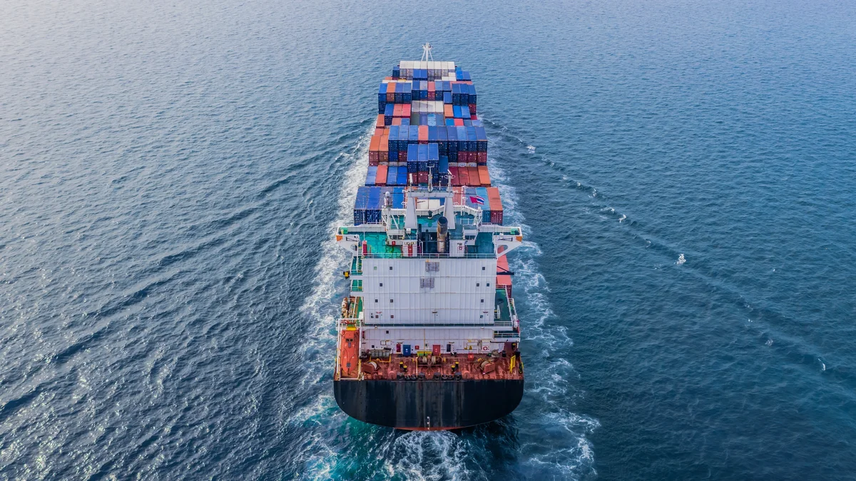 Aerial view of freighter at sea away