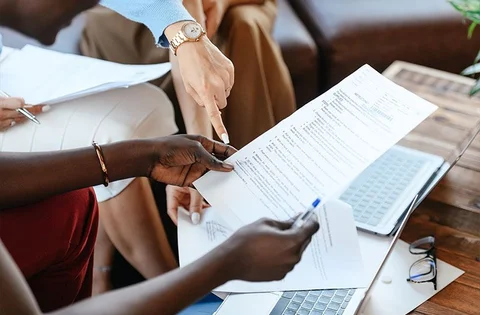People reading and pointing at a document
